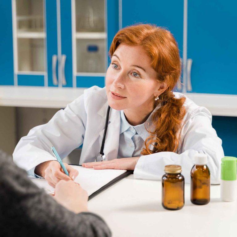 Dr. Tetgure discussing homeopathy benefits with patient